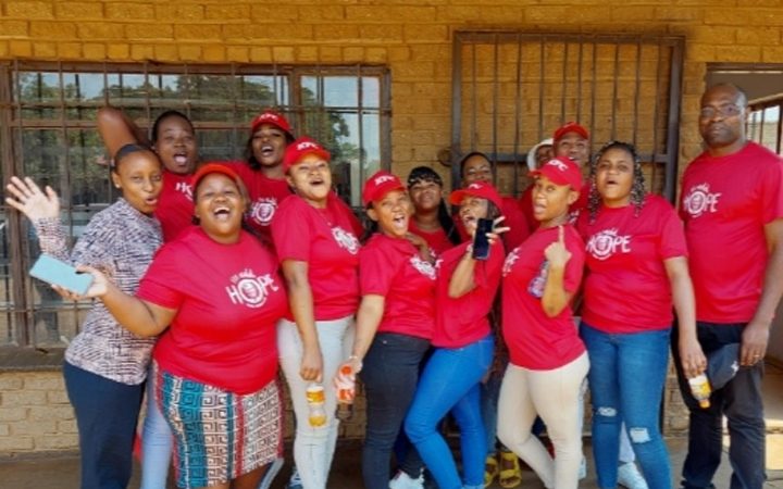KFC Hazelden staff (In Red 'Add Hope' t-shirts with Nomsa (Pta Sunrise RC) outside Kutumelo Molefe admin block.